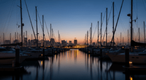 Twilight at a luxury Singapore yacht marina with masts and city skyline